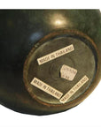 Close-up of vintage green bronze urn base with three MADE IN THAILAND labels and a small handwritten sticker.
