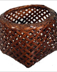 Brown rattan woven basket with a rounded top and pointed triangular base, vintage Thai design, close-up view.