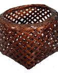 Brown rattan woven basket with a rounded top and pointed triangular base, vintage Thai design, close-up view.