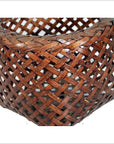 Close-up of a brown rattan woven basket with a detailed crisscross pattern and rich textured surface.
