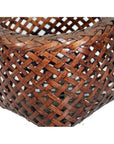 Close-up of a brown rattan woven basket with a detailed crisscross pattern and rich textured surface.