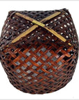 Brown rattan woven basket with rounded shape and open lattice design, vintage Thai style, close-up.
