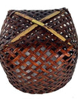 Brown rattan woven basket with rounded shape and open lattice design, vintage Thai style, close-up.