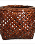 Brown rattan woven basket with open crisscross lattice design, vintage Thai style, close-up.