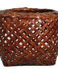 Brown rattan woven basket with open crisscross lattice design, vintage Thai style, close-up.