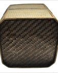 Dark woven rattan basket, close-up of the bottom showing a tight crisscross pattern.
