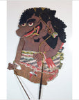 Colorful cowhide shadow puppet with curly hair and large nose, Balinese Wayang Kulit, close-up.