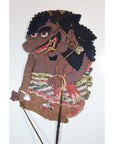 Colorful cowhide shadow puppet with curly hair and large nose, Balinese Wayang Kulit, close-up.