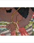 Close-up of brown cowhide arm and hand of Balinese Wayang Kulit shadow puppet with patterned garment.