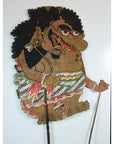 Close-up of antique Balinese Wayang Kulit shadow puppet, carved cowhide with bold features and ornate patterned attire.