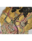 Gold-accented cowhide Wayang Kulit shadow puppet with intricate patterns, elaborate costume, close-up.