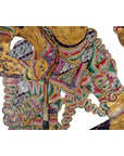 White and gold cowhide Wayang Kulit Balinese shadow puppet with intricate patterns, close-up on white background.