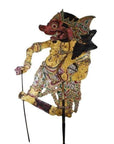 Tan cowhide Wayang Kulit shadow puppet with intricate carvings and two control sticks, classic Balinese style, close-up.