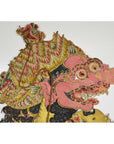 Close-up of pink-faced Balinese cowhide Wayang Kulit shadow puppet with large nose, fangs, Javanese headdress.