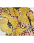 Close-up of gold, red, and black Wayang Kulit shadow puppet made from Balinese cowhide with ornate patterns.