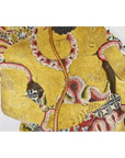 Close-up of gold, red, and black Wayang Kulit shadow puppet made from Balinese cowhide with ornate patterns.