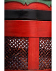 Close-up of red and black woven Wedding Basket with subtle green accents at the base.