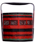 Close-up of red and black wedding basket with green accents, black handle, and open side slats.