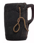Close-up of a dark wood mug with handle and rope looped through a hole near the rim, Wooden Indian Pitcher With Rope.