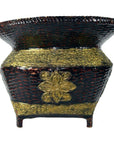 Brown woven bamboo basket with wide flared rim, floral pattern, gilt accents on raised base, close-up.