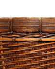 Close-up of a natural woven basket with intricate horizontal and diagonal patterns on a white background.