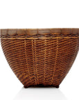 Large round rattan woven basket with wide opening, natural color, close-up on white background.