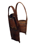Natural rattan woven basket with two compartments and tall handles, close-up, for organized storage.