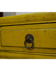 Close-up of yellow wood drawer with distressed finish and round metal pull handle from Yellow Side Tables.