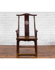Dark wood Chinese Qing Dynasty armchair with carved splat, high back, and curved armrests, front view.