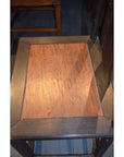 Close-up of a dark brown wood Yoke Back Chair with burl wood seat.