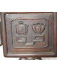 Dark brown Yumu wood Chinese chair with hand-carved décor and lacquered finish, shown against a neutral background.