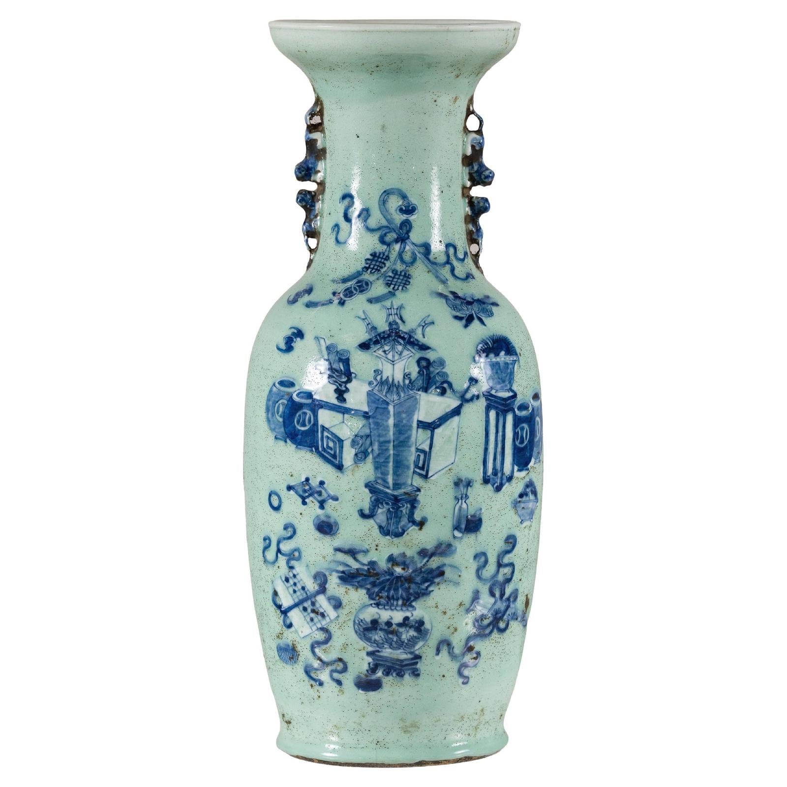 Pale green celadon porcelain vase with cobalt blue scholar images and decorative handles, 19th century, close-up.