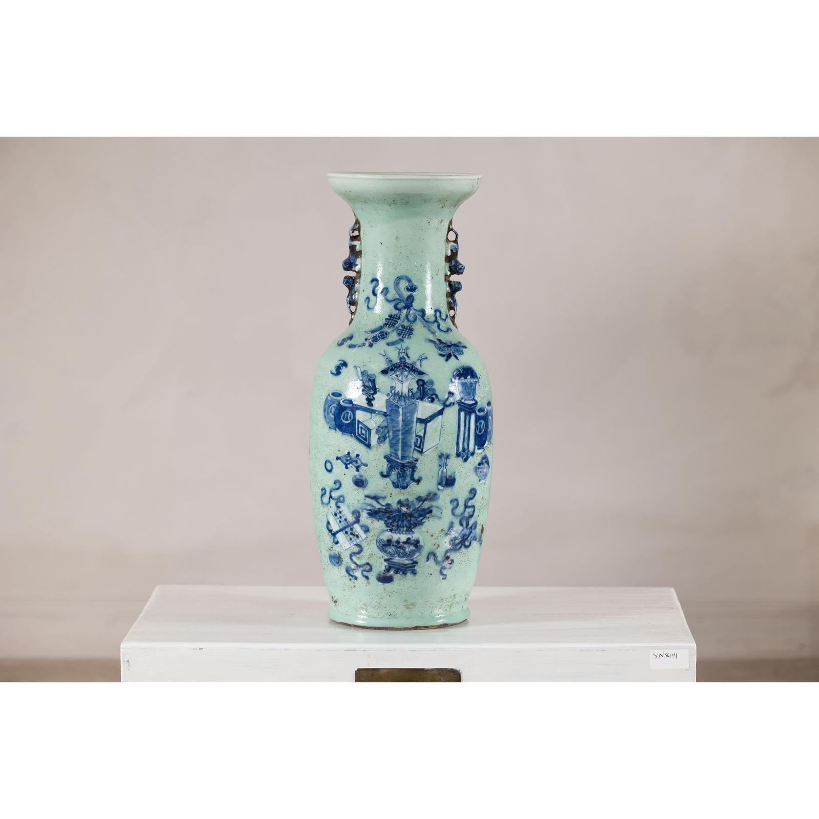 Cobalt blue and white porcelain vase with scholar images, displayed on a white pedestal against a plain background.