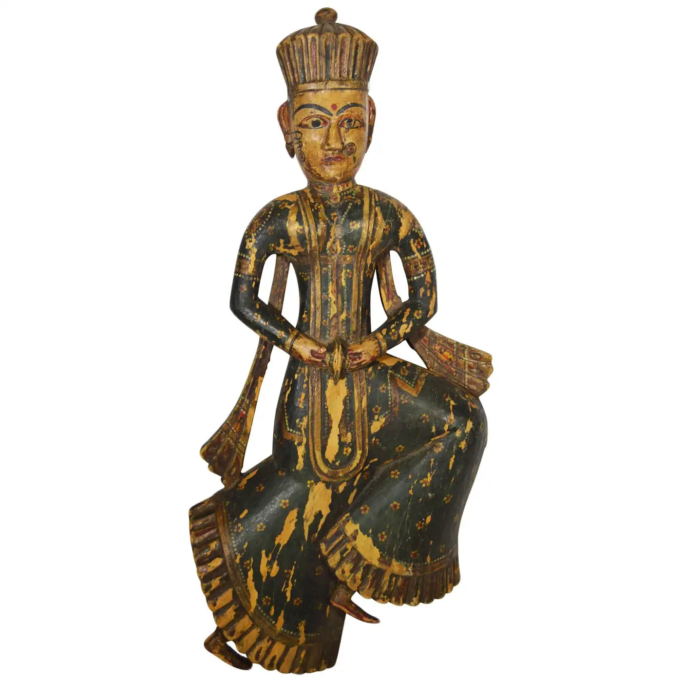 Close-up of antique Indonesian hand-carved wood temple statue with ornate painted clothing and tall headdress, 20th century.