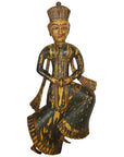 Close-up of antique Indonesian hand-carved wood temple statue with ornate painted clothing and tall headdress, 20th century.