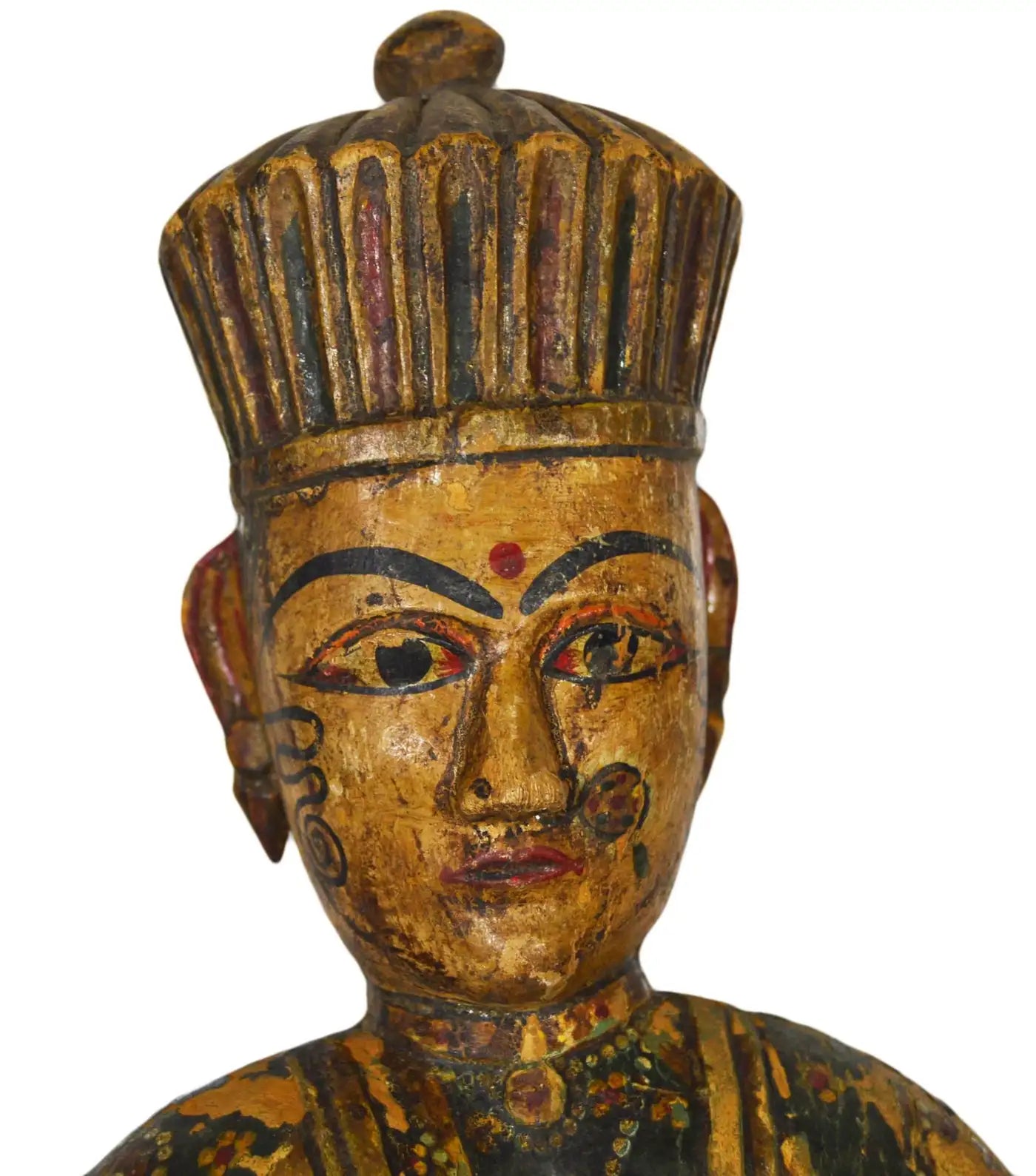 Close-up of a hand-carved, painted antique Indonesian temple statue with a crowned figure on a white background.