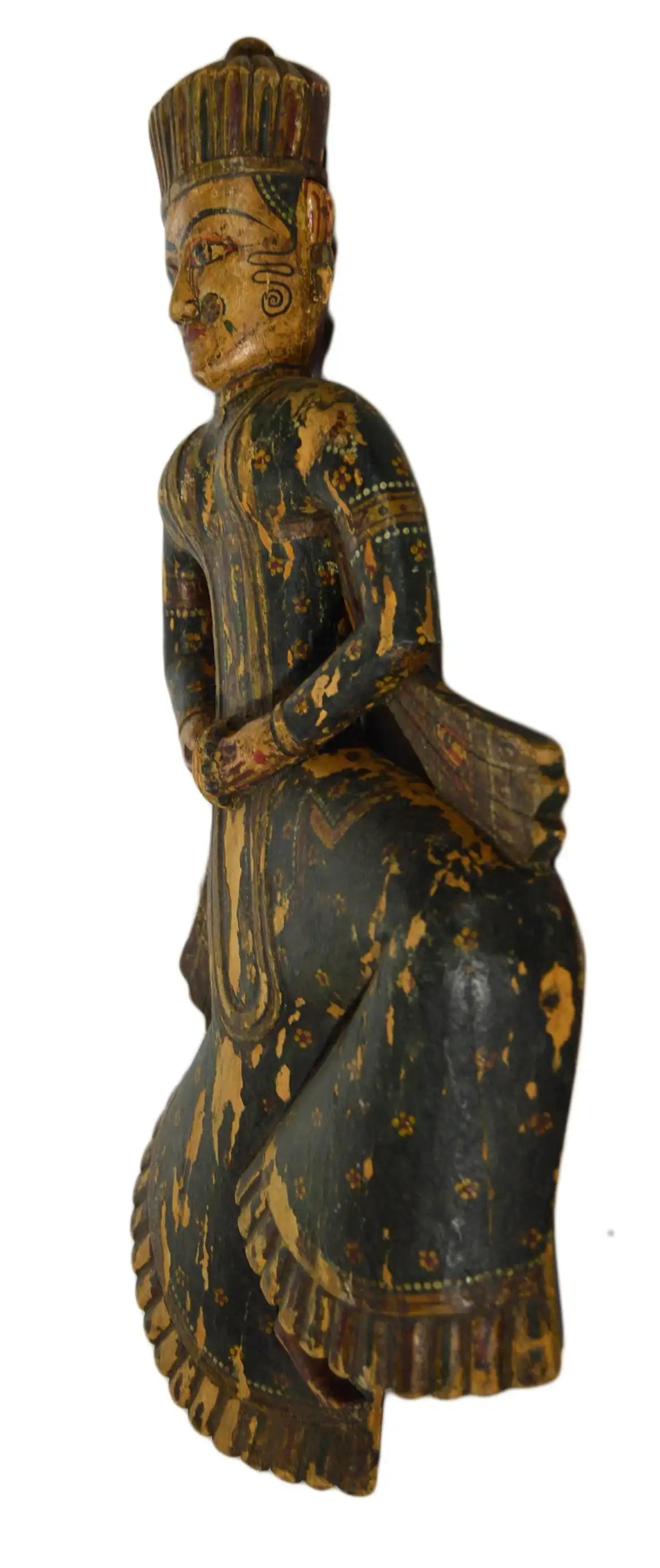 Wooden figurine of a seated figure with intricate carvings on a white background