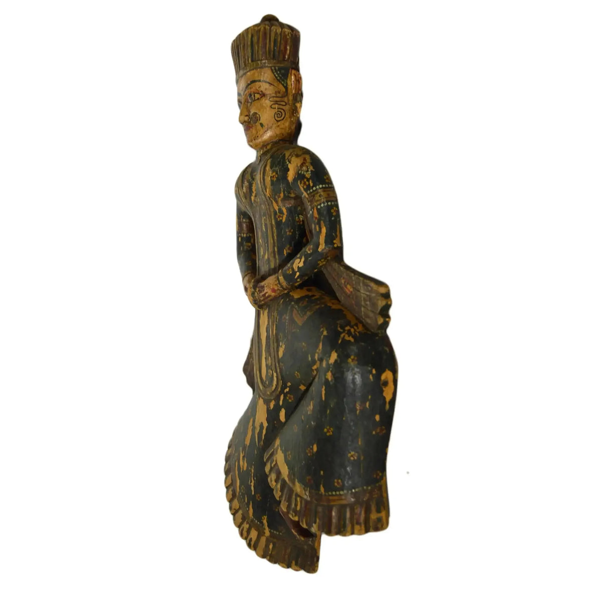 Wooden figurine of a seated figure with intricate carvings on a white background