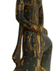 Wooden figurine of a seated figure with intricate carvings on a white background