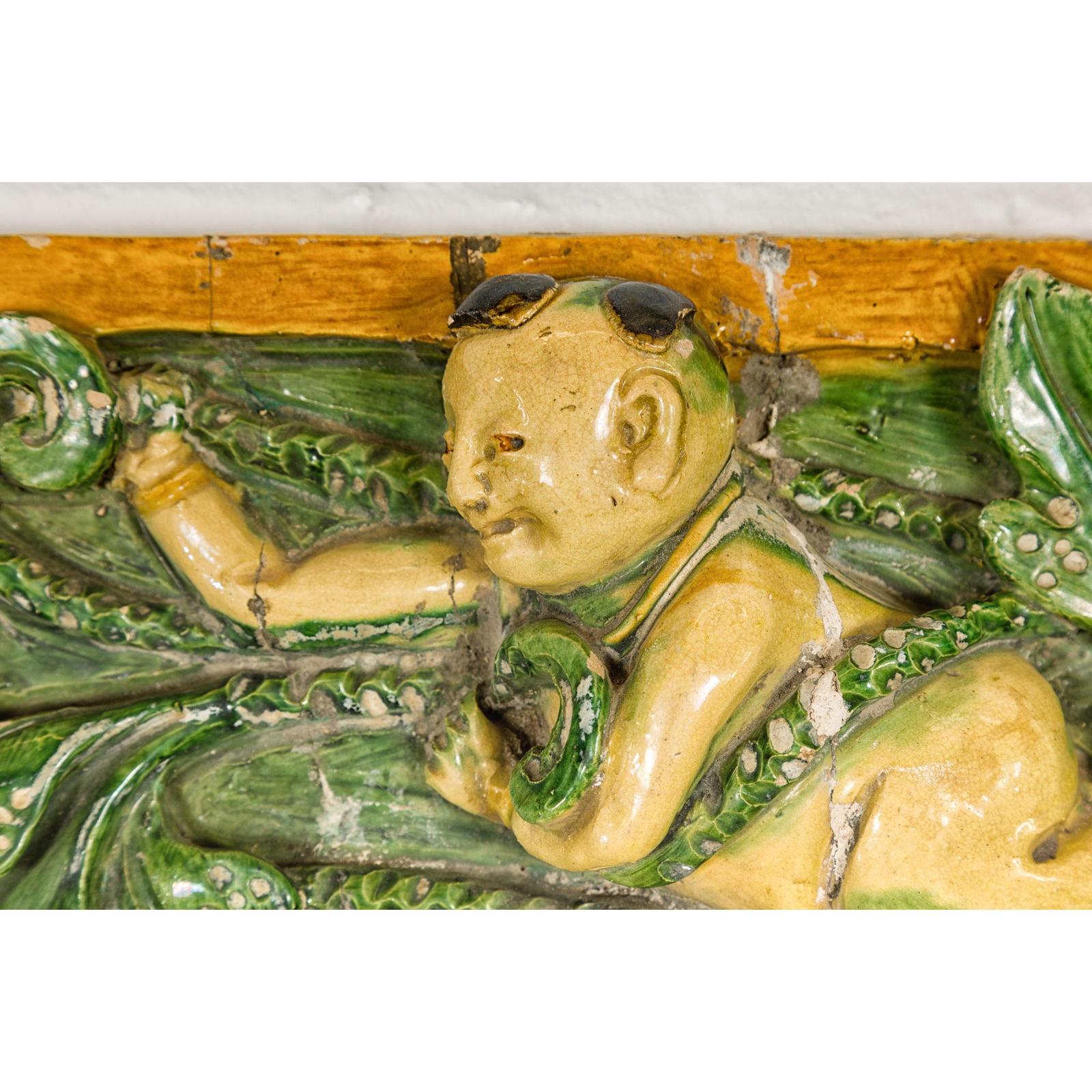 Qing Dynasty Tricolor Roof Fragment from a Temple Depicting a Boy Amidst Leaves