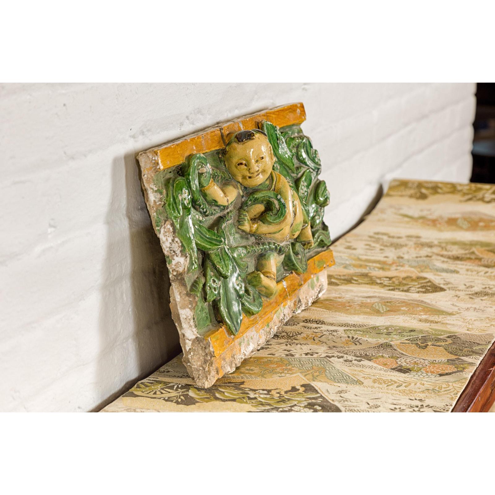 Qing Dynasty Tricolor Roof Fragment from a Temple Depicting a Boy Amidst Leaves