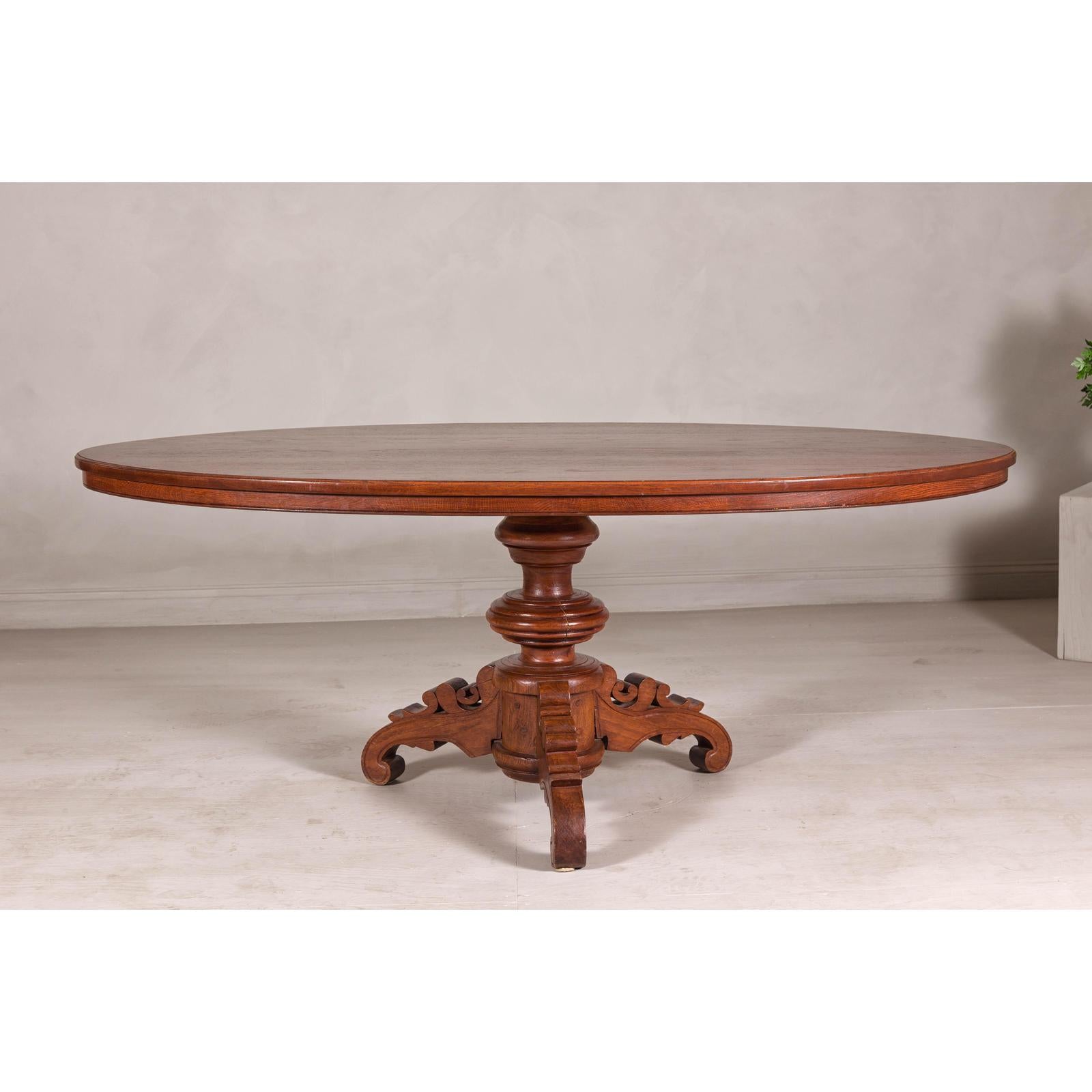 Dutch Colonial Oval Pedestal Dining Table with Scrolling Base, Late 19th Century