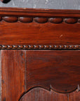 Brown wooden Javanese armoire with two carved doors, 20th century, from Indonesia, against white background.