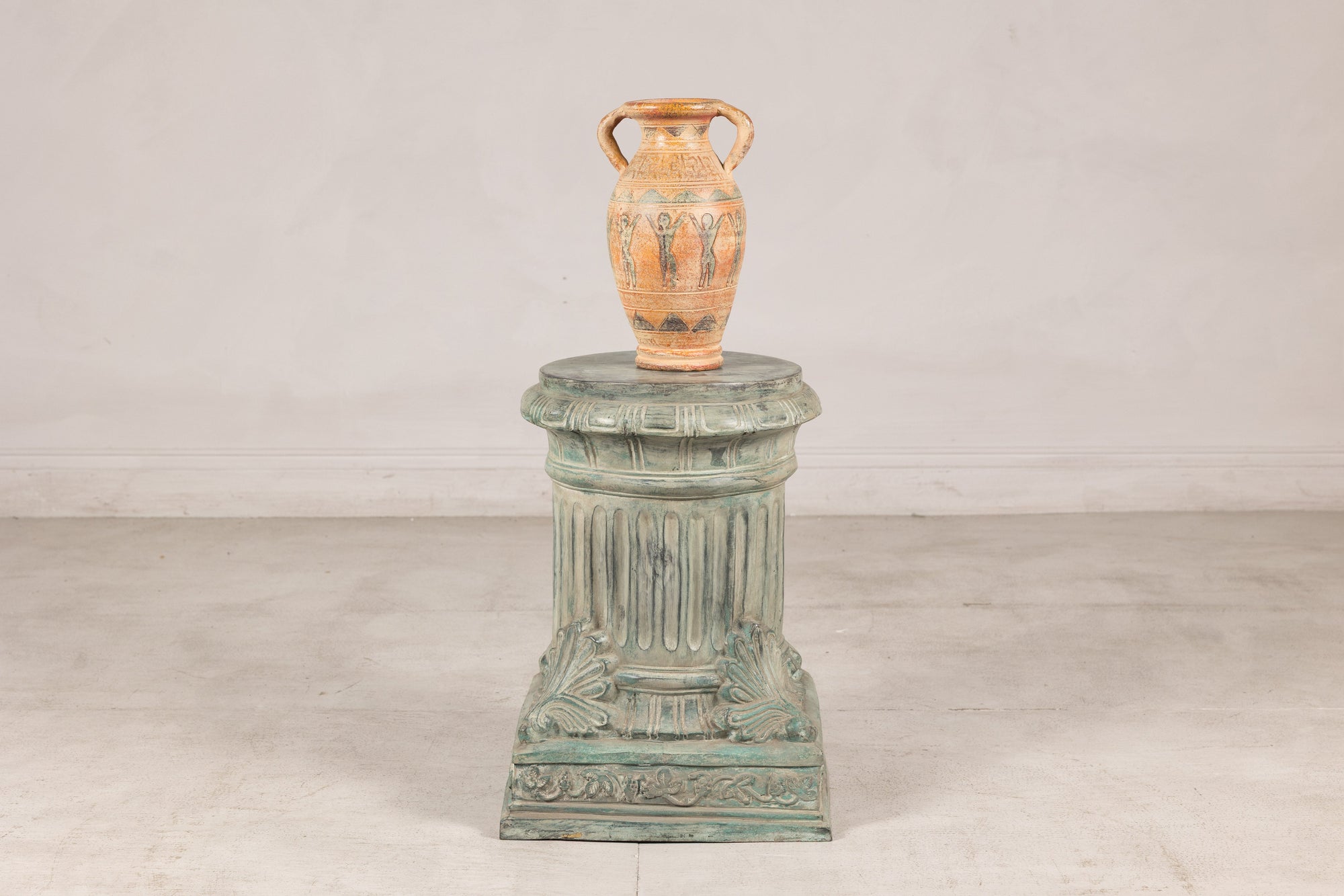 Verdigris bronze pedestal styled with a ceramic vase