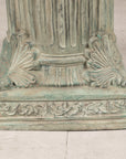 Close-up of verdigris bronze pedestal base and palmette details