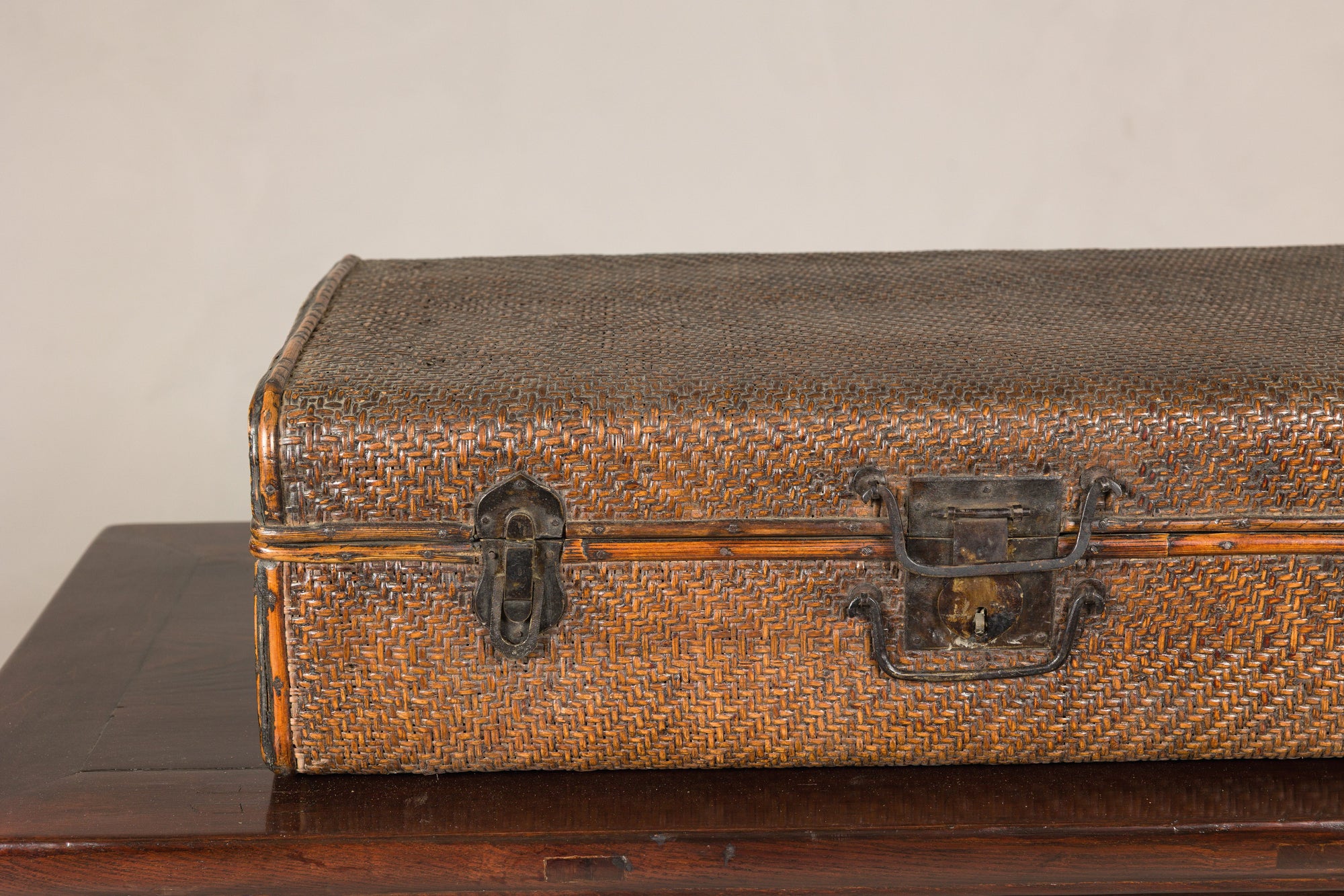 Close-up of rattan trunk front and dark iron hardware