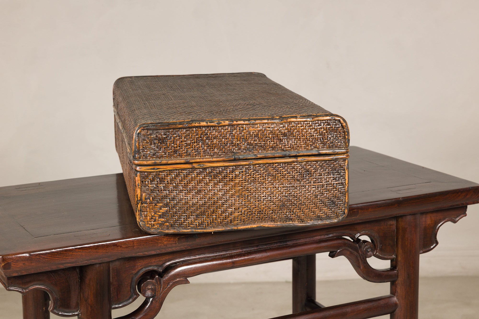 Woven rattan suitcase trunk, side view