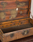 Open woven rattan trunk showing wood-lined interior