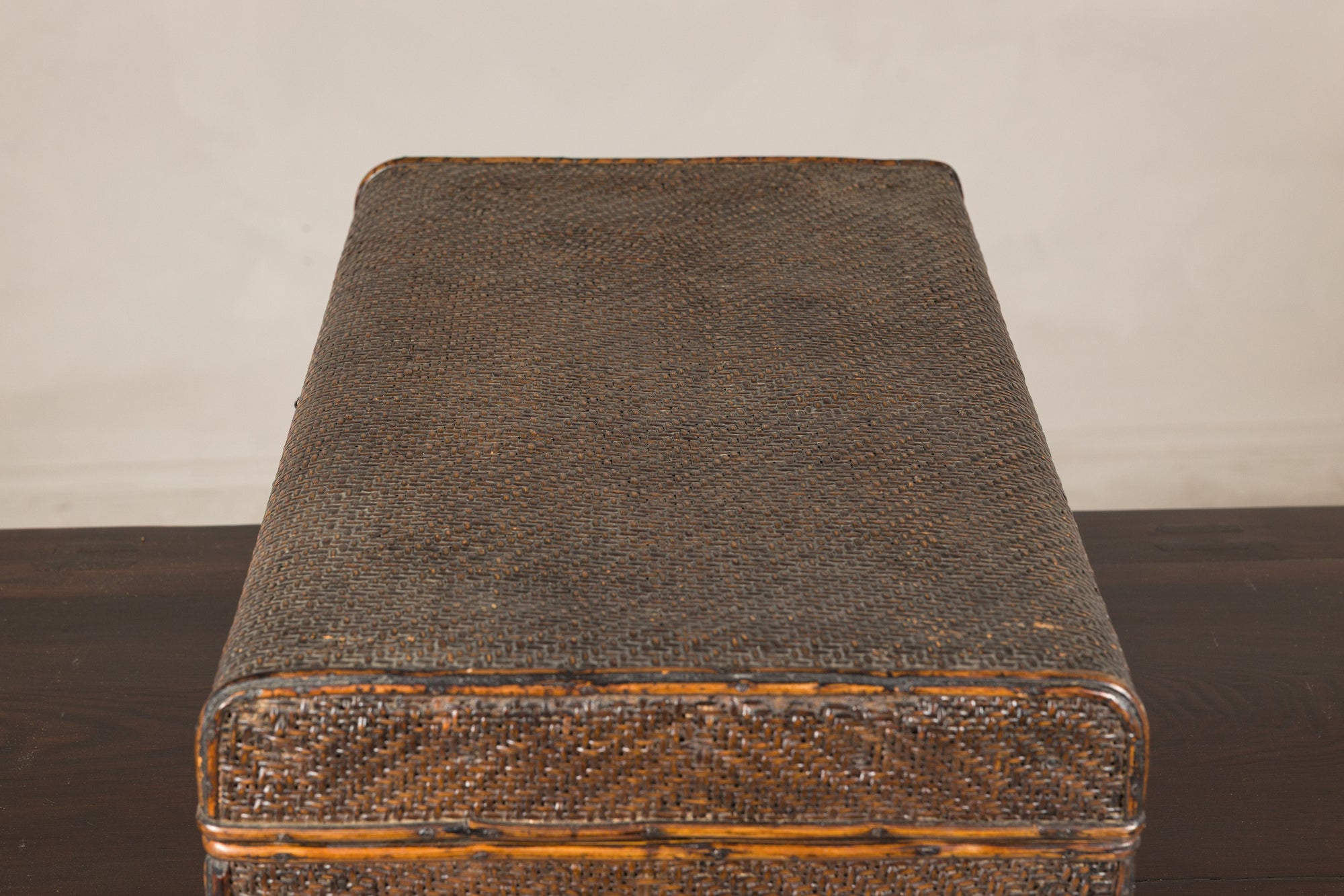 Close-up of woven rattan trunk lid and rounded corner