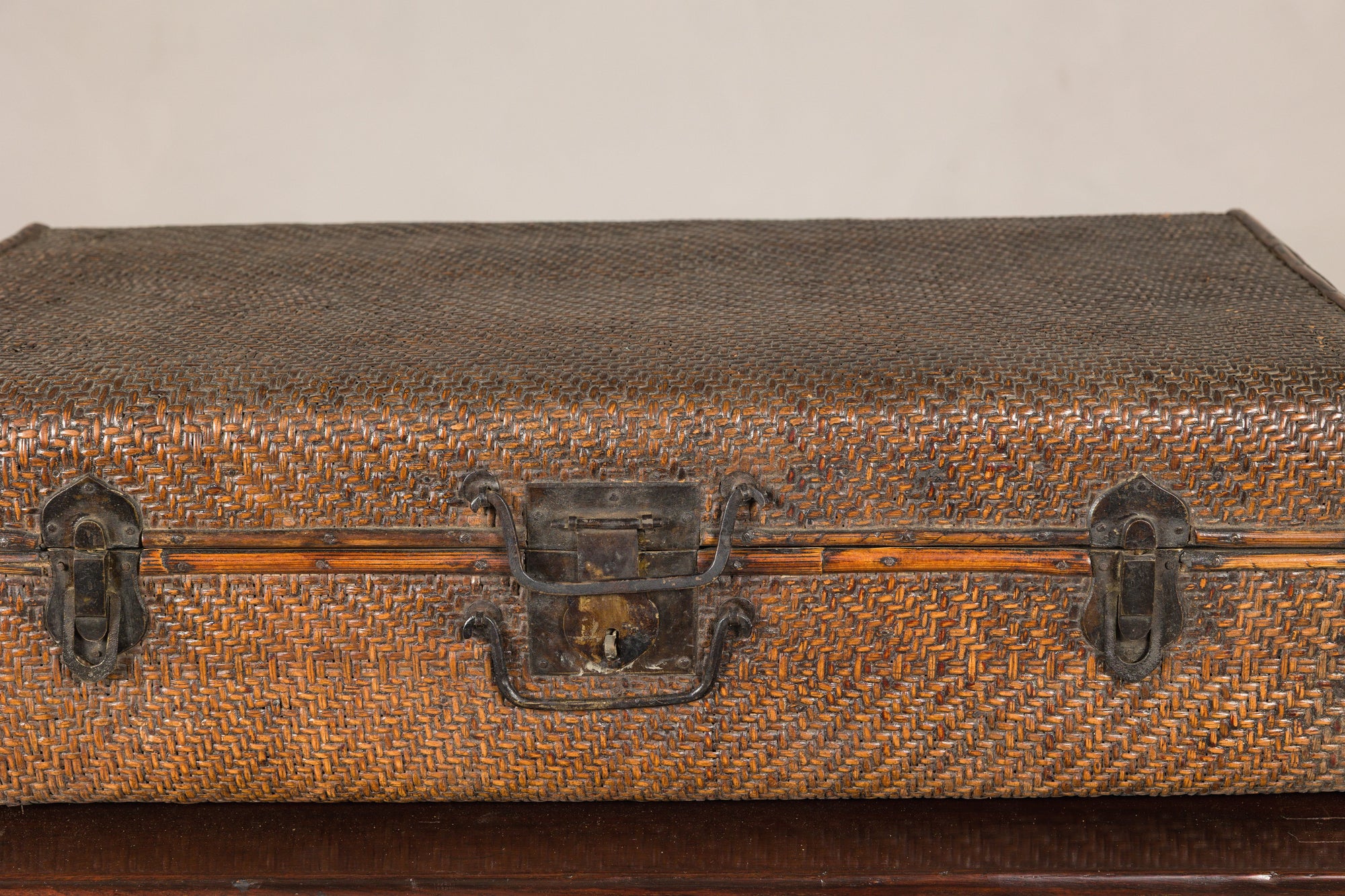 Close-up of woven rattan trunk handle, lock and latches